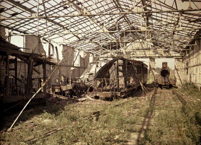 The burned out railroad and streetcar yard with a few damaged vehicles and a locomotive, Soissons, Aisne, France, 1917 by Fernand Cuville